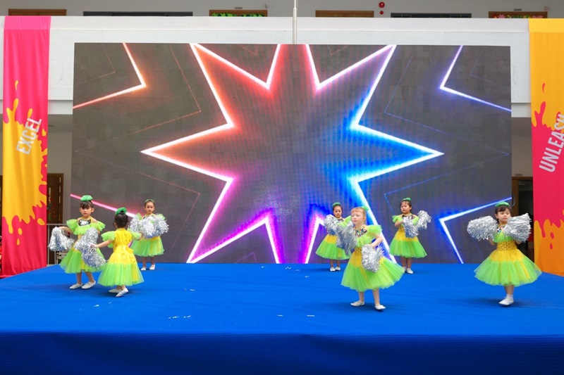 A group of young girls dancing on a stageDescription automatically generated